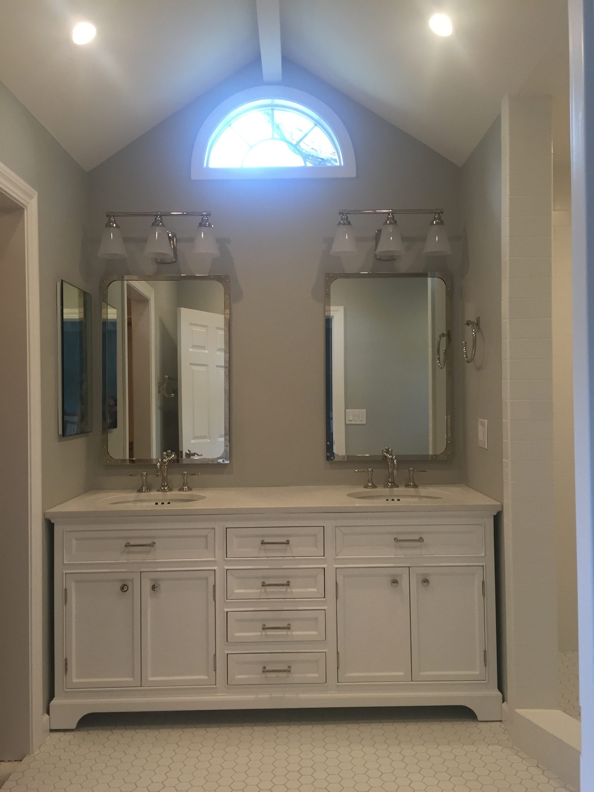1980’s bathroom gets a major makeover with vaulted ceilings and new windows