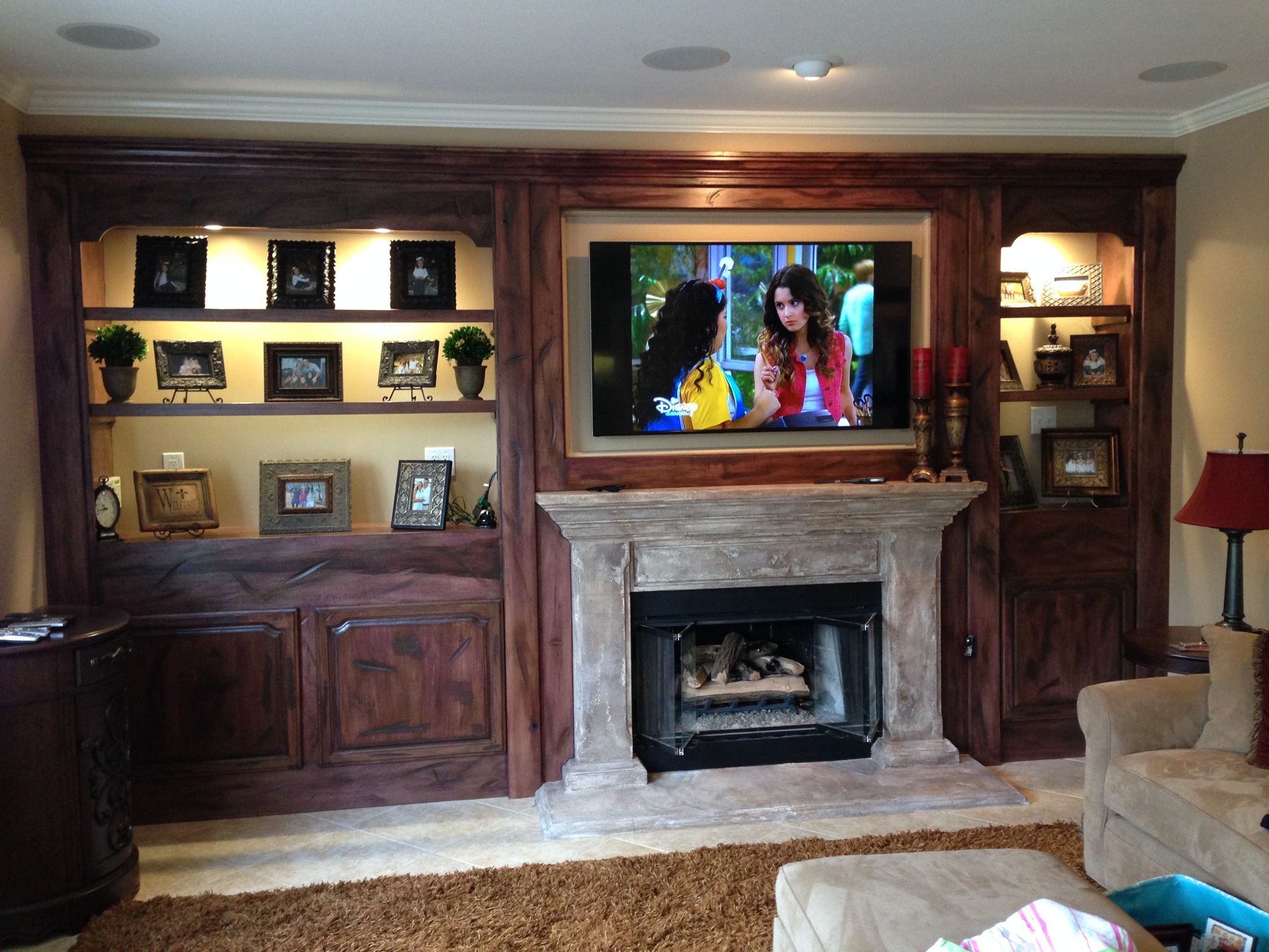 Rustic And Weathered Alder TV Wall Unit With Glass Shelves And Custom Lighting
