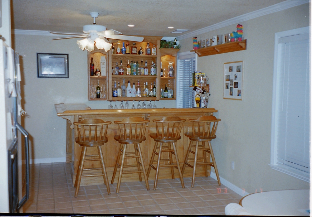 Custom fully functional wet bar complete with shelving, sink, and countert